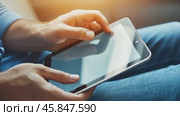 Person using a tablet device. Digital interactions and activities. Man holding a pad. Remote learning, social distance working, ordering buying online, reading e book. Close-Up view, Modern Technology. Стоковое AI-видео, аниматор Марина Демидюк / Фотобанк Лори