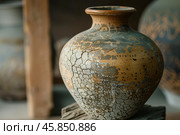 Old clay vase showing craquelure from age sitting on shelf. Стоковое AI-изображение, AI-художник Иван Рябоконь / Фотобанк Лори