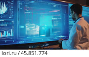 Expert Analyzing Data on Large Screen at a Tech Facility During Night Shift for Critical Decisions. Стоковое AI-видео, аниматор Sergey Grishin / Фотобанк Лори