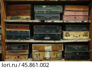 Old wooden boxes stacked on shelves creating nostalgic atmosphere. Стоковое AI-изображение, AI-художник Иван Рябоконь / Фотобанк Лори
