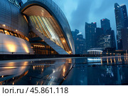 Esplanade theatres reflecting on wet pavement at blue hour in singapore. Стоковое AI-изображение, AI-художник Иван Рябоконь / Фотобанк Лори