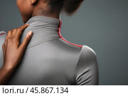 Athlete woman touching breathable sportswear on grey background. Стоковое AI-изображение, AI-художник Иван Рябоконь / Фотобанк Лори