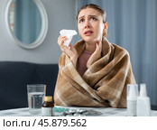 Woman with fever symptoms sitting at home. Стоковое фото, фотограф Яков Филимонов / Фотобанк Лори