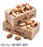 Delicious nougat bars with almonds and nuts on white background. Стоковое AI-изображение, AI-художник Иван Рябоконь / Фотобанк Лори