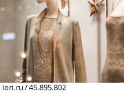 An elegant showcase of an expensive luxury store with stylish mannequins in clothes and evening lighting. The concept of shopping and sales. Стоковое фото, фотограф Photojuli / Фотобанк Лори