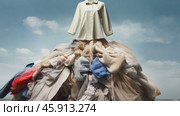 A big pile of things collected from a landfill. The concept of overconsumption, overspending and buying unnecessary things and clothes. Reusing second-hand. A world global problem. Стоковое AI-видео, аниматор ALLA YURTAYEVA / Фотобанк Лори