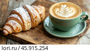 Green ceramic cup of frothy cappuccino coffee with croissants on rustic wood background. Hot latte with art milk foam and freshly-baked Brioche on cafe table. Breakfast or coffee break. Morning ritual. Стоковое AI-изображение, AI-художник Марина Демидюк / Фотобанк Лори