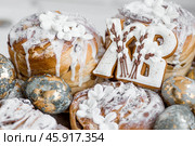 Banner for Orthodox Easter. Easter eggs with gold, Easter cakes and gingerbread in the shape of the letters XB in a woven basket made of vines. Стоковое фото, фотограф Photojuli / Фотобанк Лори