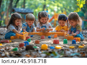 Five children playing in a sandbox outdoors. They are enthusiastically building sand castles and forts using brightly colored molds and toy buckets. The children look happy and engaged. Their clothes are bright and comfortable: T-shirts, overalls and dresses. The girls wear bows in their hair, and the boy has a short haircut. The sandbox is surrounded by greenery, and a playground can be seen in the distance. Light sunlight filters through the trees, creating a warm and cheerful atmosphere. Leaves and natural elements add an autumnal accent to the picture. Стоковое AI-изображение, AI-художник Анна Кривицкая / Фотобанк Лори