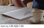 A Creative Workspace Complete with Coffee and a Notebook for Inspiration and Comfort. Стоковое видео, видеограф PAv / Фотобанк Лори