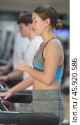 In gym, girl does exercises using treadmill. Young group of athletes trains in gym. Physical education and sports, active healthy lifestyle. Стоковое видео, видеограф Яков Филимонов / Фотобанк Лори