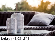 Interior details. A minimalistic composition of the modern interior of the veranda of a country house. Two stylish iron candlesticks on a glass table. The patio. Стоковое фото, фотограф Photojuli / Фотобанк Лори