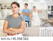 Woman and guy swear at girl. Mom and older brother scold young girl for unsuccessful studies at university. Complex intergenerational relationships. Стоковое фото, фотограф Яков Филимонов / Фотобанк Лори