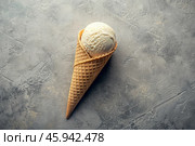 Sweet dessert. Ice cream cones with different flavors on a concrete gray background. World Ice Cream Day. Стоковое AI-изображение, AI-художник Photojuli / Фотобанк Лори