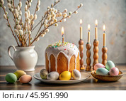 Orthodox Easter. Easter cake, painted eggs, icons, faces of saints, flowers, church candles and Easter decor on a wooden table in an old village house. Стоковое AI-изображение, AI-художник Photojuli / Фотобанк Лори