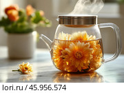 Colorful flowers steeping in a glass kettle with steam rising gently. Стоковое AI-изображение, AI-художник Katsiaryna Repich / Фотобанк Лори