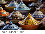 Colorful tajines displayed, celebrating moroccan pottery craftsmanship. Стоковое AI-изображение, AI-художник Иван Рябоконь / Фотобанк Лори