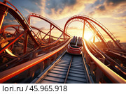 Rollercoaster descending during sunset in an amusement park. Стоковое AI-изображение, AI-художник Иван Рябоконь / Фотобанк Лори