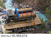 Mountain road infrastructure. A unique design for moving transportation over a steep cliff. A truck on a platform descends on rails. Стоковое фото, фотограф Роман Дзюбало / Фотобанк Лори