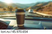 Coffee cup on a car dashboard during a road trip. Стоковое AI-изображение, AI-художник Екатерина Усенко / Фотобанк Лори