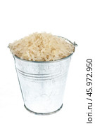 Full bucket of rice grains on a white background. Стоковое фото, фотограф Александр Собко / Фотобанк Лори