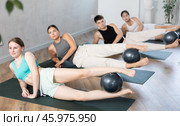 Girl participates in group lesson with sof tball, modern sport in studio. Стоковое фото, фотограф Яков Филимонов / Фотобанк Лори