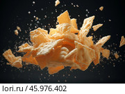 Crunchy cornflakes flying and splashing on black background. Стоковое AI-изображение, AI-художник Иван Рябоконь / Фотобанк Лори