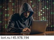 The hacker is working on a laptop, digital codes on a virtual background. Hacking and protecting online data. Digital technologies, software development. Стоковое AI-изображение, AI-художник Photojuli / Фотобанк Лори