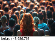 Woman with long red hair standing out from the crowd. Стоковое AI-изображение, AI-художник Иван Рябоконь / Фотобанк Лори