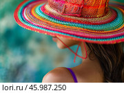 Woman wearing colorful raffia sun hat enjoying summer vacation. Стоковое AI-изображение, AI-художник Иван Рябоконь / Фотобанк Лори