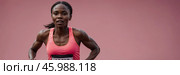 Runner competes in a race against a vivid pink backdrop on a sunny day outdoors, showcasing determination and athleticism. Стоковое AI-изображение, AI-художник Сергей Толмачёв / Фотобанк Лори