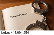 Handcuffs on open book, financial crimes and legal action, highlighting law enforcement against fraud, corruption, and economic offenses. Стоковое AI-изображение, AI-художник Павел Муравьев / Фотобанк Лори