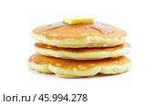 Stack of three fluffy pancakes topped with melting butter and drizzled with syrup, isolated on white background, breakfast or brunch photography, delicious homemade food. Стоковое фото, фотограф Павел Муравьев / Фотобанк Лори