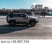 Jetour Traveller car moving in the street. Man is driving fast SUV Jetour T2 in beige color on a city road. Редакционное фото, фотограф Константин Григорьев / Фотобанк Лори