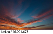 Vibrant sunset colors paint the sky above a horizon filled with tranquil clouds. Стоковое AI-изображение, AI-художник Сергей Толмачёв / Фотобанк Лори
