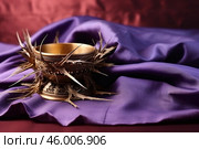 Crown of thorns embracing golden chalice on purple cloth, symbol of sacrifice and redemption. Стоковое AI-изображение, AI-художник Иван Рябоконь / Фотобанк Лори