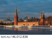 Vodovzvodnaya, Blagoveshchenskaya and Borovitskaya towers on the Kremlin embankment of the Moskva River and the Moscow City Business Center in the background on a sunny winter day, Moscow, Russia. Стоковое фото, фотограф Ula Ulachka / Фотобанк Лори