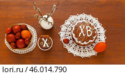 Flat lay of Easter composition with homemade Easter cake on lace handmade napkin, pussy willow branches and painted red Easter eggs on wooden table. On Easter cake letters ХВ mean Christ is Risen. Стоковое фото, фотограф Виктория Катьянова / Фотобанк Лори