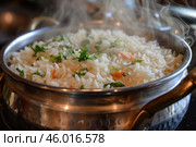 Steaming basmati rice with herbs and vegetables in metallic pot. Стоковое AI-изображение, AI-художник Иван Рябоконь / Фотобанк Лори