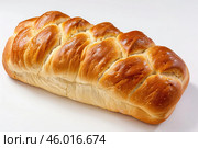 Braided challah bread loaf resting on white background. Стоковое AI-изображение, AI-художник Иван Рябоконь / Фотобанк Лори