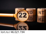 Magnifying glass showing number twenty two and discount word in the background. Стоковое AI-изображение, AI-художник Иван Рябоконь / Фотобанк Лори