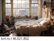 Unmade bed in artist's messy studio apartment bathed in morning sunlight. Стоковое AI-изображение, AI-художник Иван Рябоконь / Фотобанк Лори