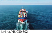 Container cargo Ship Arrival - Aerial View. Containers In Freight Ship. Video above huge colorful container carrier vessel cruising deep blue open ocean sea. Global transportation, logistics business. Стоковое AI-видео, аниматор Марина Демидюк / Фотобанк Лори