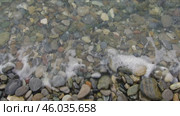 A sea wave washes over the shore, carrying small stones with it. A video that soothes and calms. Морская волна набегает на берег, унося с собой мелкие камешки. Видео, которое успокаивает. Стоковое видео, видеограф Валерий Тесаков / Фотобанк Лори