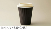 Blank brown coffee paper cup with white lid mockup. Disposable paper tea cup isolated on beige. Togo Cup packaging for design, logo, text. Hygienic cooking or home delivery concept. Banner, template. Стоковое AI-изображение, AI-художник Марина Демидюк / Фотобанк Лори