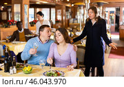Resentful wife scolding her husband spending time with another woman at dinner. Стоковое фото, фотограф Яков Филимонов / Фотобанк Лори