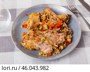 Lunch is served on plate - baked pieces of young rabbit and pearl barley. Стоковое фото, фотограф Яков Филимонов / Фотобанк Лори