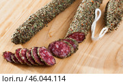 Sliced spanish sausage fuet with herbs. Стоковое фото, фотограф Яков Филимонов / Фотобанк Лори
