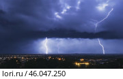 Lightning thunderstorm. Lightning strikes on a dark sky. Flashes of lightening storm over modern city residential area. Bolts striking in the horizon. Stormy Night. Thunderstorm. Thunderbolt, thunder. Стоковое AI-видео, аниматор Марина Демидюк / Фотобанк Лори