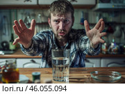 Man refusing alcohol in kitchen showing stop sign with hands. Стоковое AI-изображение, AI-художник Иван Рябоконь / Фотобанк Лори